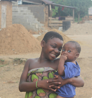 Image of a girl carrying a baby